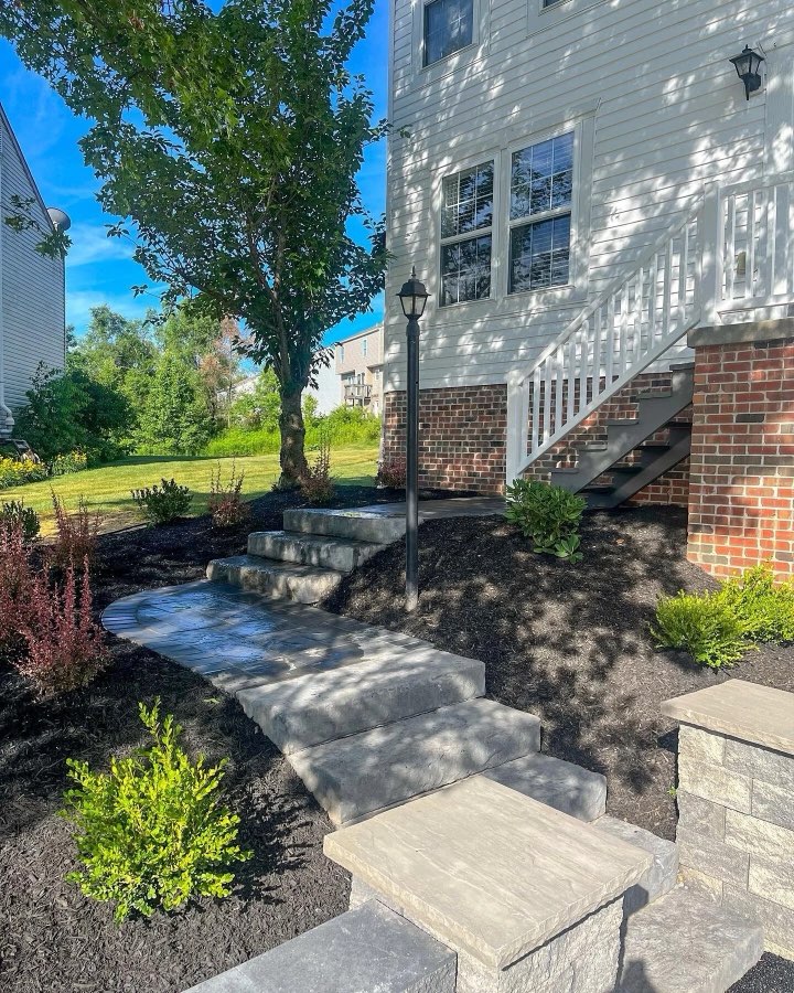 Paver walkway with retaining wall and new plantings