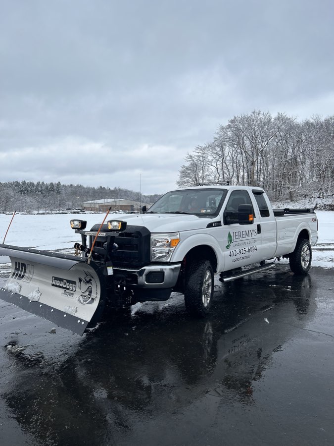 Snow removal equipment clearing a lot